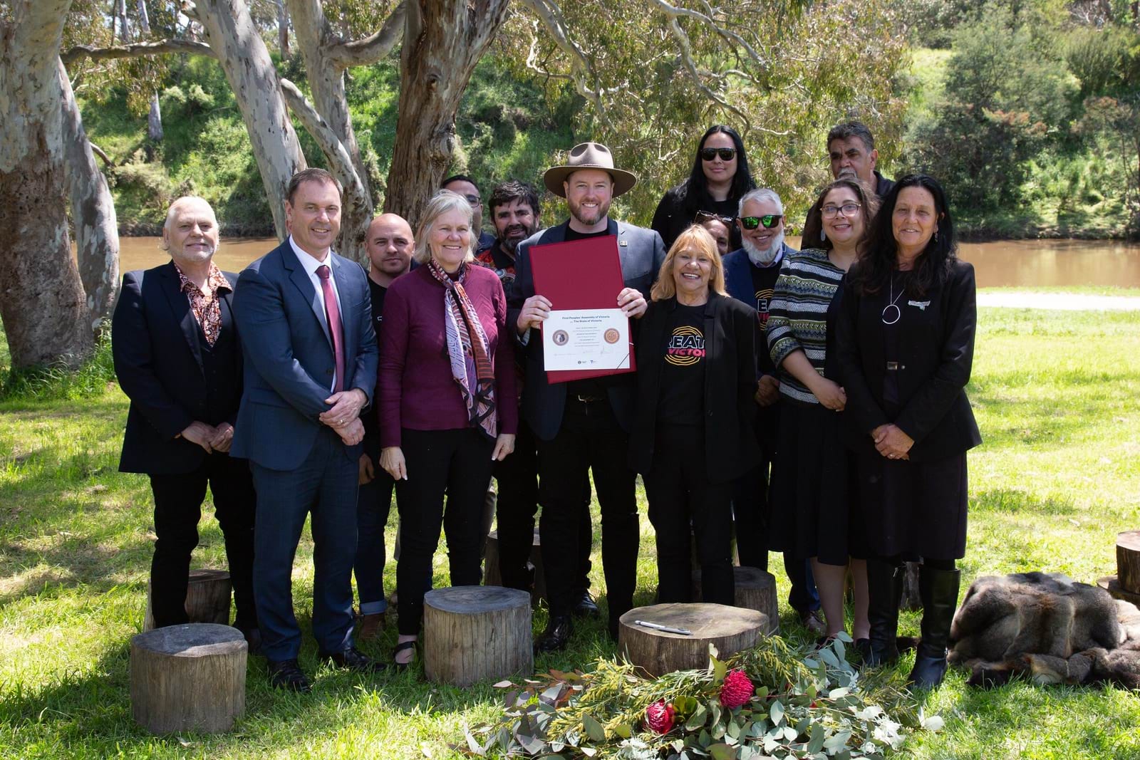 Members of the First Peoples' Assembly of Victoria and Colin Brooks MP holding the signed Treaty Negotiation Framework and Self-determination Fund