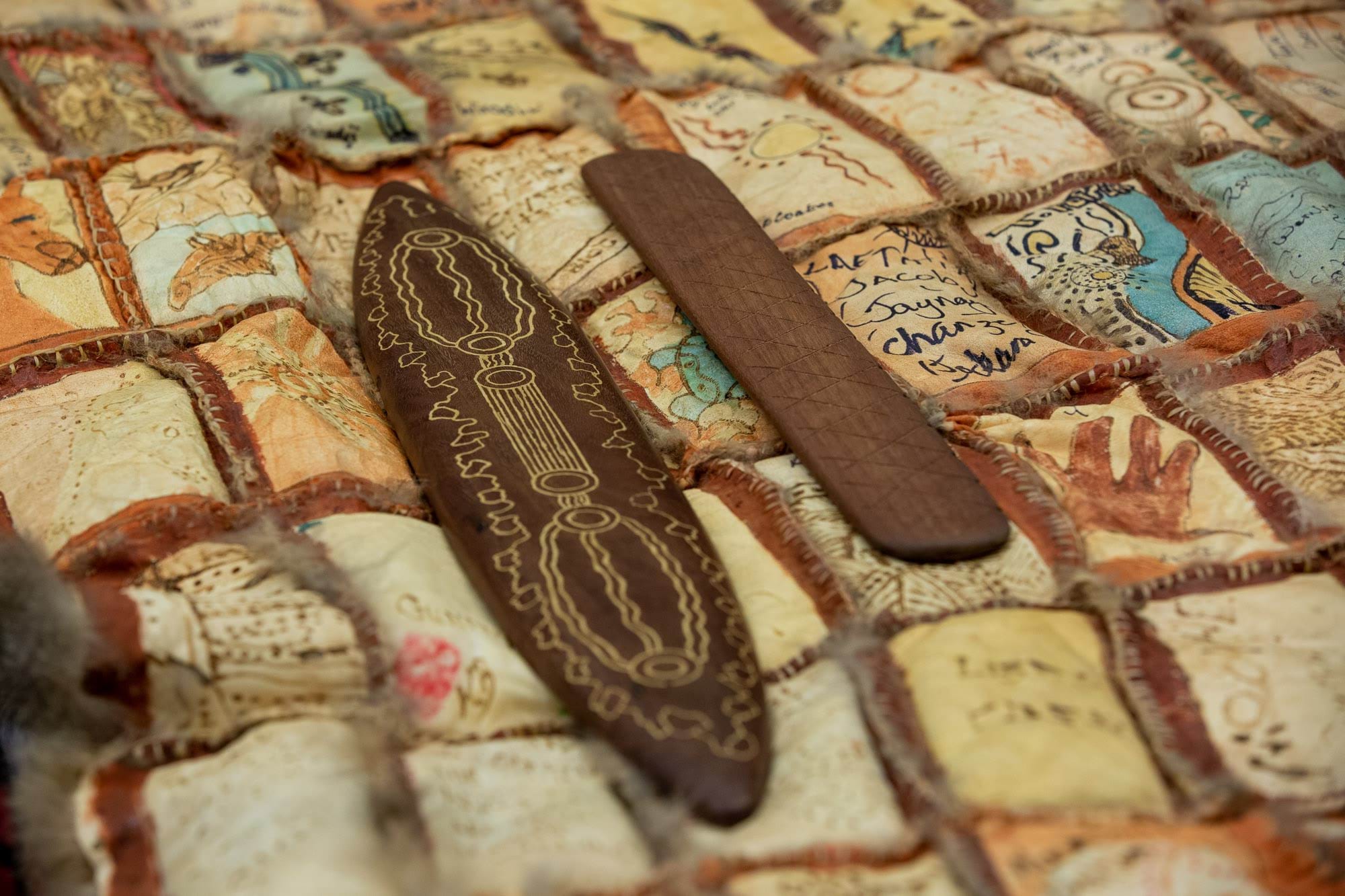 Message sticks on possum skin cloak